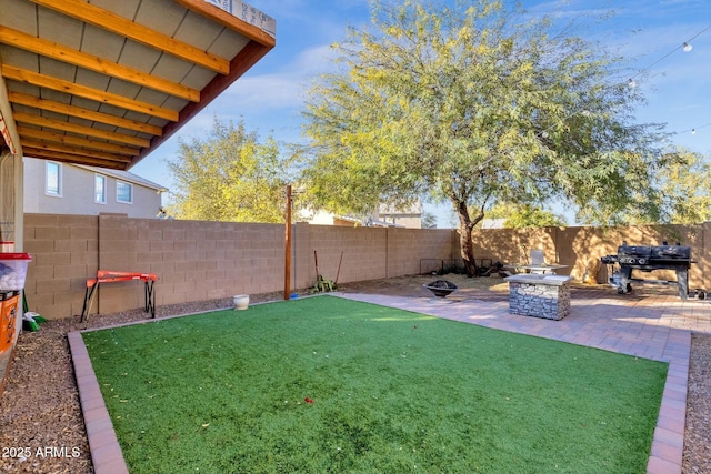 view of yard featuring an outdoor fire pit and a patio