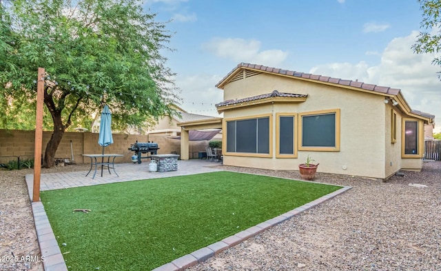 back of house featuring a yard and a patio area