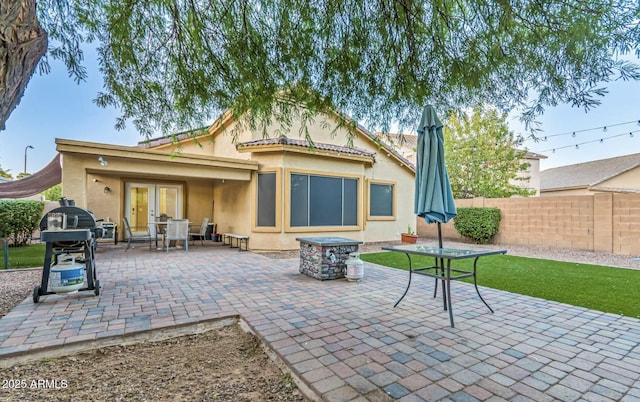 back of property with a patio and french doors