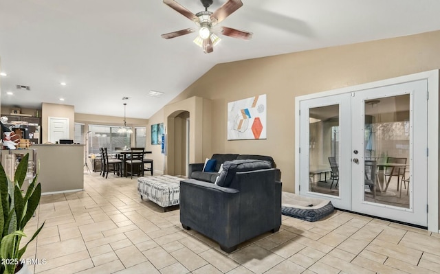 living room with lofted ceiling, french doors, and ceiling fan