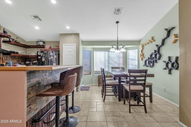 dining room with indoor bar and a notable chandelier