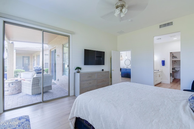 bedroom with multiple windows, ceiling fan, and light hardwood / wood-style floors