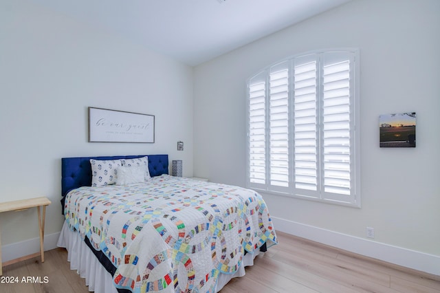 bedroom featuring light hardwood / wood-style flooring and multiple windows