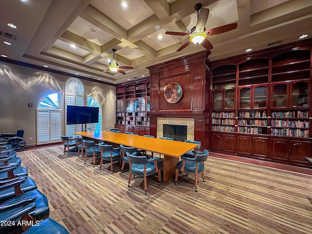 interior space with coffered ceiling, ceiling fan, beamed ceiling, a fireplace, and carpet floors