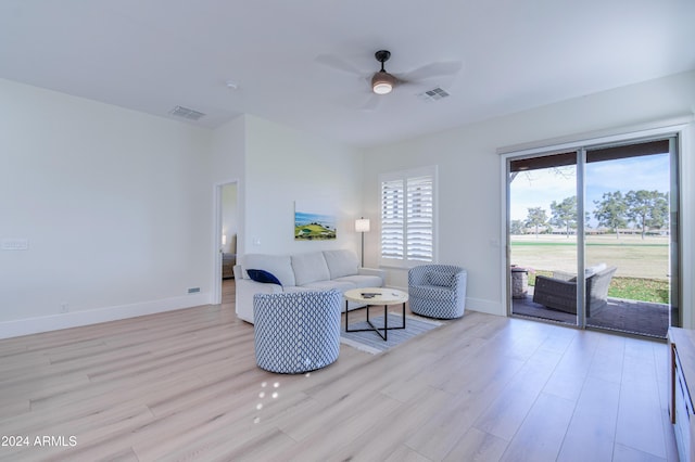 living room featuring ceiling fan and light wood-type flooring