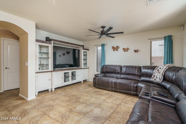 living room featuring light tile patterned floors and ceiling fan