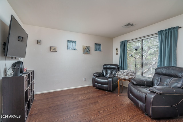 sitting room with dark wood-type flooring