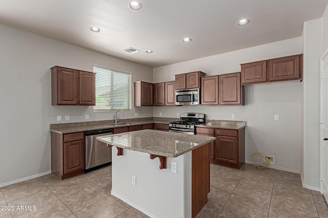 4051 E Torrey Pines Ln E, Chandler, AZ 85249 - kitchen with appliances with stainless steel finishes, recessed lighting, a kitchen island, light stone countertops, and a breakfast bar