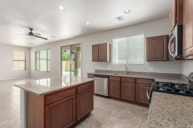 4051 E Torrey Pines Ln E, Chandler, AZ 85249 - kitchen featuring appliances with stainless steel finishes, light tile patterned floors, a center island, ceiling fan, and recessed lighting