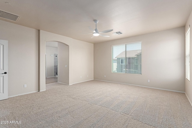 4051 E Torrey Pines Ln E, Chandler, AZ 85249 - empty room featuring arched walkways, a ceiling fan, and carpet flooring