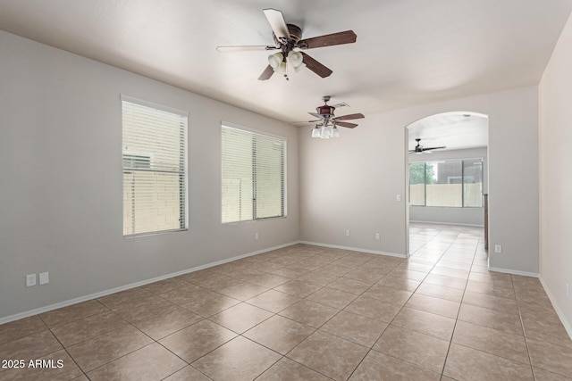 4051 E Torrey Pines Ln E, Chandler, AZ 85249 - empty room with ceiling fan, light tile patterned floors, and arched walkways
