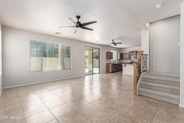 4051 E Torrey Pines Ln E, Chandler, AZ 85249 - unfurnished living room featuring light tile patterned flooring, ceiling fan, and stairway