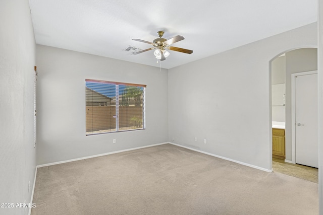 2861 E Morenci Rd, San Tan Valley, AZ 85143 - empty room featuring light carpet, ceiling fan, and arched walkways