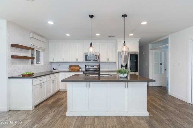 1820 W Seldon Way, Phoenix, AZ 85021 - kitchen with stainless steel appliances, dark countertops, light wood-style flooring, tasteful backsplash, and recessed lighting