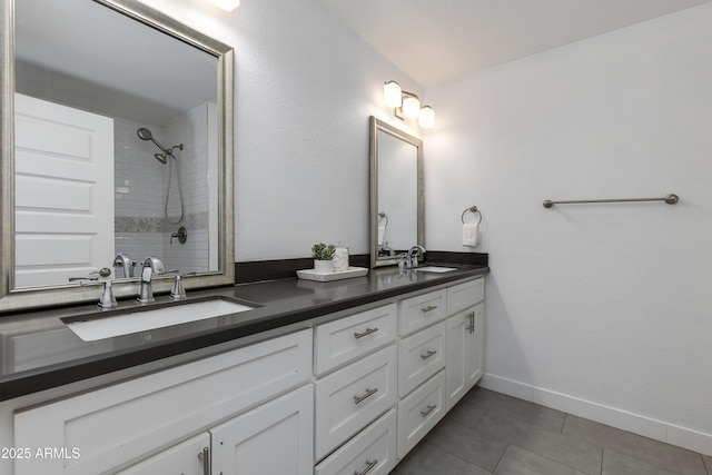 1820 W Seldon Way, Phoenix, AZ 85021 - bathroom featuring double vanity, tile patterned floors, tiled shower, and baseboards