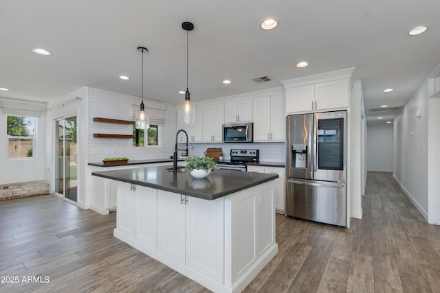 1820 W Seldon Way, Phoenix, AZ 85021 - kitchen featuring stainless steel appliances, dark countertops, healthy amount of natural light, white cabinets, and recessed lighting