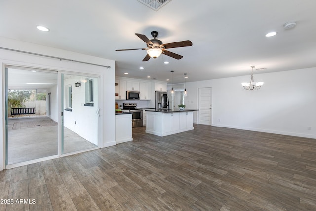 1820 W Seldon Way, Phoenix, AZ 85021 - kitchen with appliances with stainless steel finishes, dark countertops, open floor plan, a ceiling fan, and dark wood finished floors