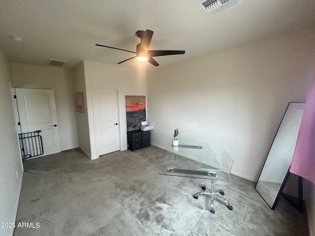 unfurnished office with ceiling fan and carpet floors