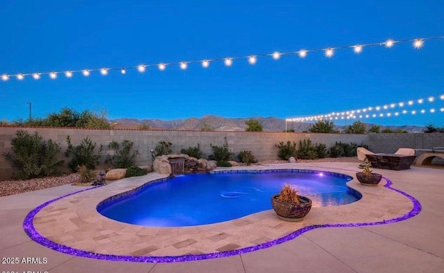 view of swimming pool featuring a fire pit, a patio area, and a fenced backyard