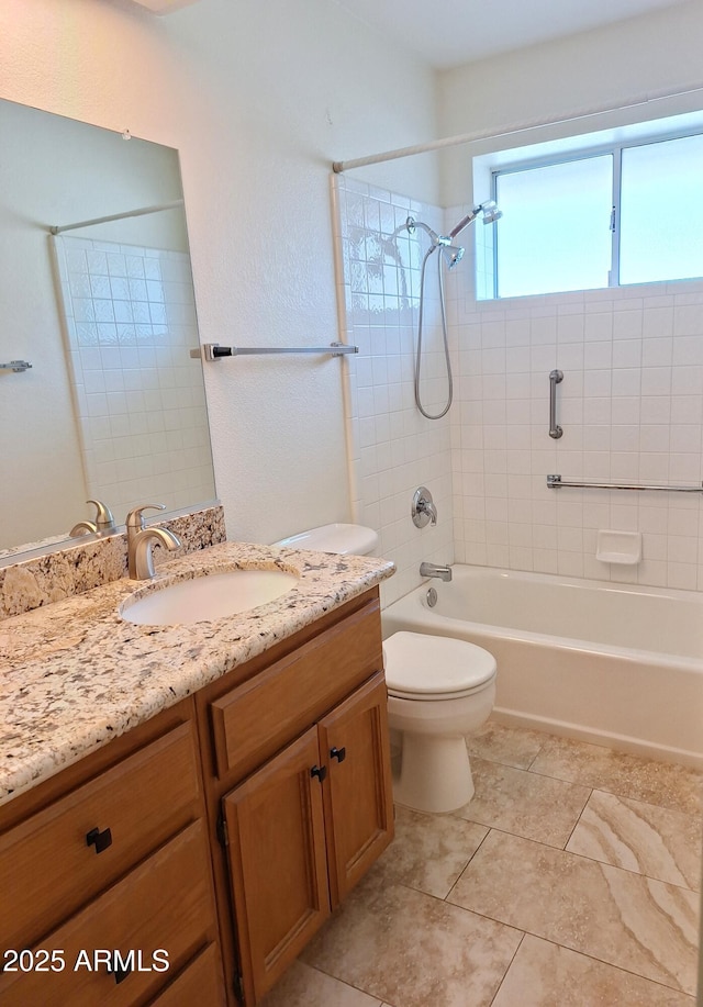 full bathroom featuring vanity, toilet, and tiled shower / bath