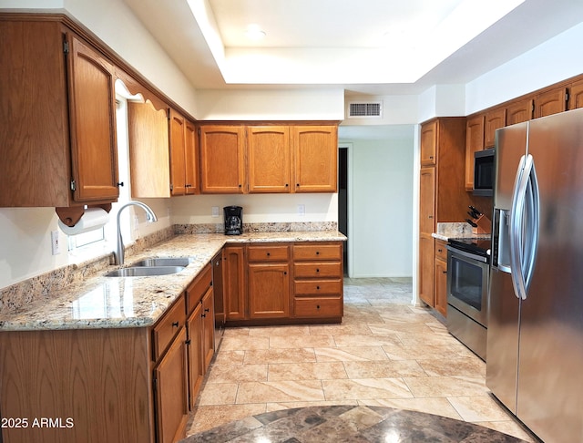 kitchen with sink, black appliances, and light stone counters