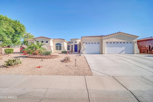 3125 W Desert Ln, Laveen, AZ 85339 - mediterranean / spanish-style home featuring an attached garage, stucco siding, concrete driveway, and a tiled roof