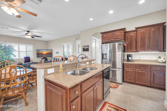 3125 W Desert Ln, Laveen, AZ 85339 - kitchen with stainless steel fridge with ice dispenser, dishwasher, a center island with sink, recessed lighting, and light stone counters