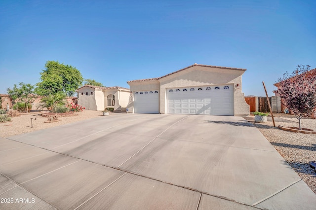 3125 W Desert Ln, Laveen, AZ 85339 - view of front of home featuring stucco siding, a garage, concrete driveway, and a tile roof