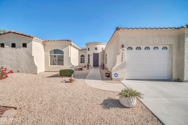 3125 W Desert Ln, Laveen, AZ 85339 - mediterranean / spanish-style house featuring stucco siding, a garage, driveway, and a tile roof