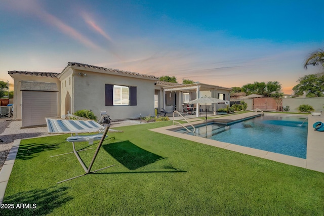 3125 W Desert Ln, Laveen, AZ 85339 - pool at dusk with a pergola, a fenced backyard, and a patio area