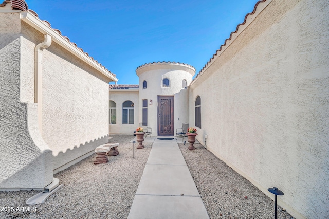 3125 W Desert Ln, Laveen, AZ 85339 - doorway to property featuring stucco siding and a tiled roof