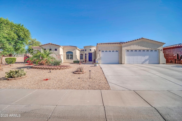 3125 W Desert Ln, Laveen, AZ 85339 - mediterranean / spanish house featuring an attached garage, stucco siding, concrete driveway, and a tiled roof