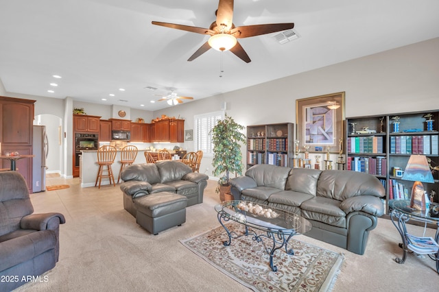 3125 W Desert Ln, Laveen, AZ 85339 - living area with light colored carpet, a ceiling fan, recessed lighting, arched walkways, and light tile patterned floors
