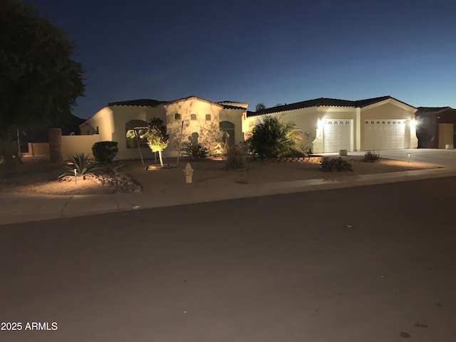 3125 W Desert Ln, Laveen, AZ 85339 - mediterranean / spanish-style house with a garage, concrete driveway, and stucco siding