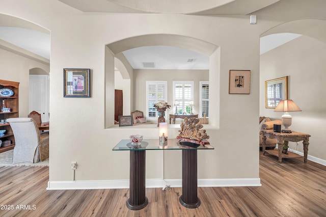 3125 W Desert Ln, Laveen, AZ 85339 - corridor with wood finished floors and arched walkways