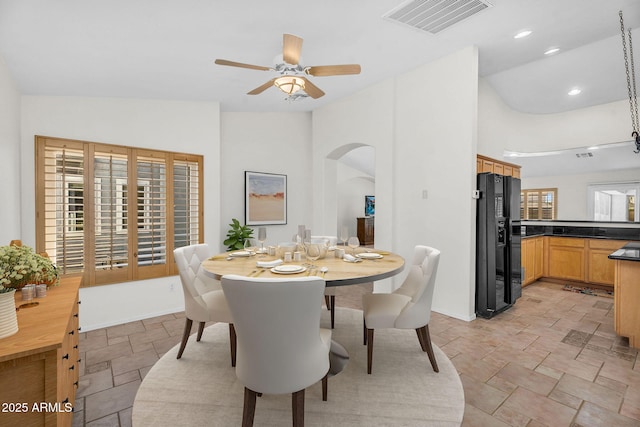 5529 E Holmes Ave, Mesa, AZ 85206 - dining area featuring stone tile flooring, arched walkways, a ceiling fan, recessed lighting, and lofted ceiling