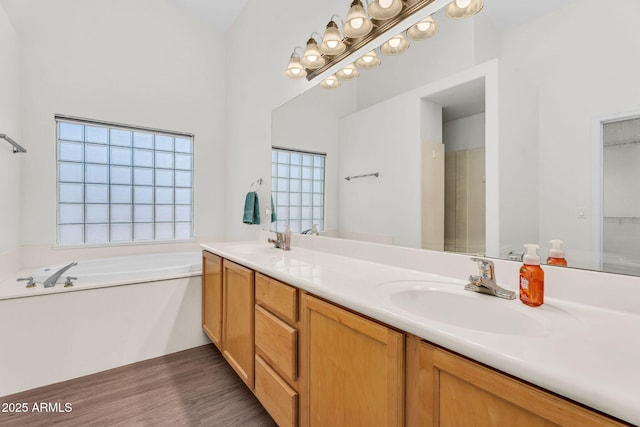 5529 E Holmes Ave, Mesa, AZ 85206 - full bathroom featuring double vanity, a bath, and wood finished floors