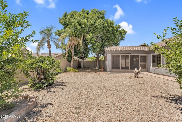 5529 E Holmes Ave, Mesa, AZ 85206 - back of property featuring a sunroom, a tiled roof, a fenced backyard, and stucco siding