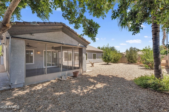 5529 E Holmes Ave, Mesa, AZ 85206 - rear view of property featuring a sunroom, a ceiling fan, a fenced backyard, a tile roof, and stucco siding