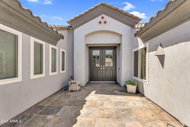 5529 E Holmes Ave, Mesa, AZ 85206 - doorway to property with french doors, stucco siding, a patio area, and a tile roof