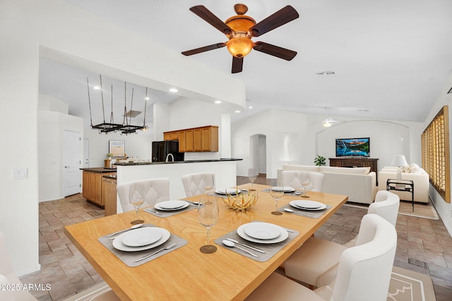5529 E Holmes Ave, Mesa, AZ 85206 - dining room featuring stone tile floors, a ceiling fan, vaulted ceiling, arched walkways, and recessed lighting