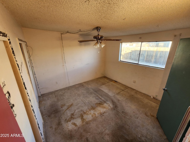 interior space with unfinished concrete flooring and a textured ceiling