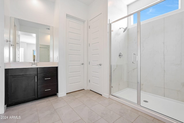 bathroom featuring tile flooring, large vanity, and an enclosed shower