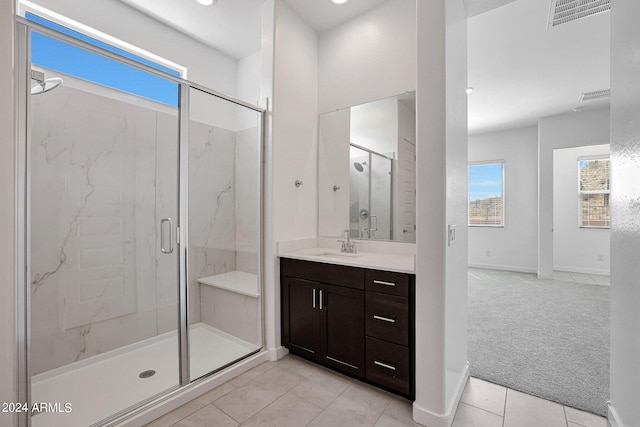 bathroom with walk in shower, tile floors, and large vanity