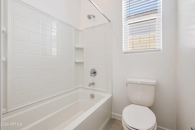 bathroom with tile floors, toilet, and bathing tub / shower combination