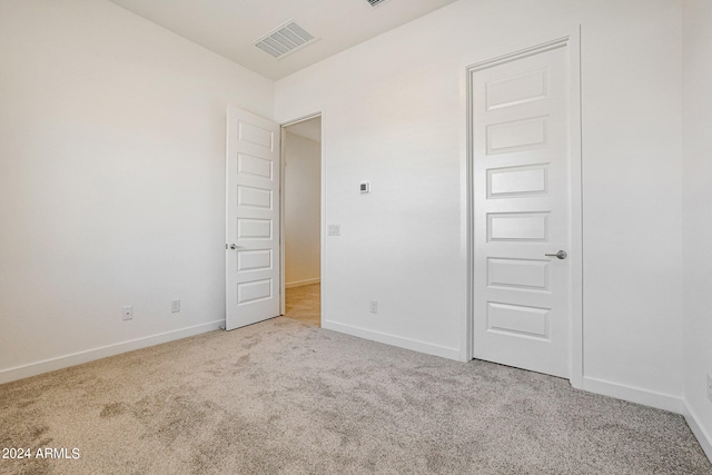 unfurnished bedroom with light colored carpet