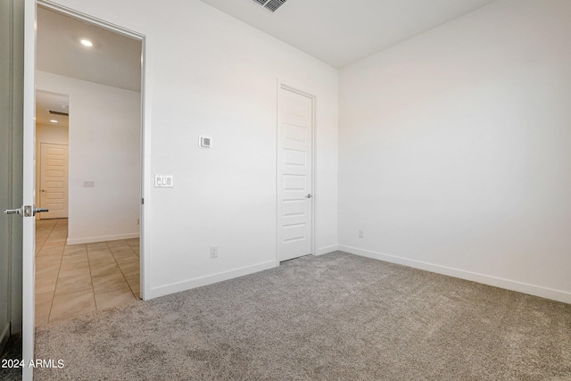 unfurnished bedroom with light colored carpet