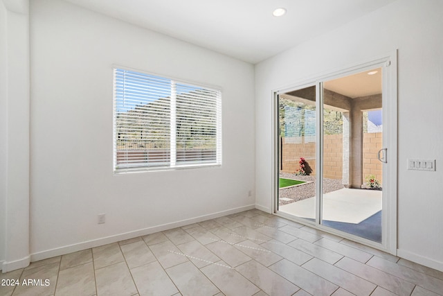 tiled spare room with a wealth of natural light