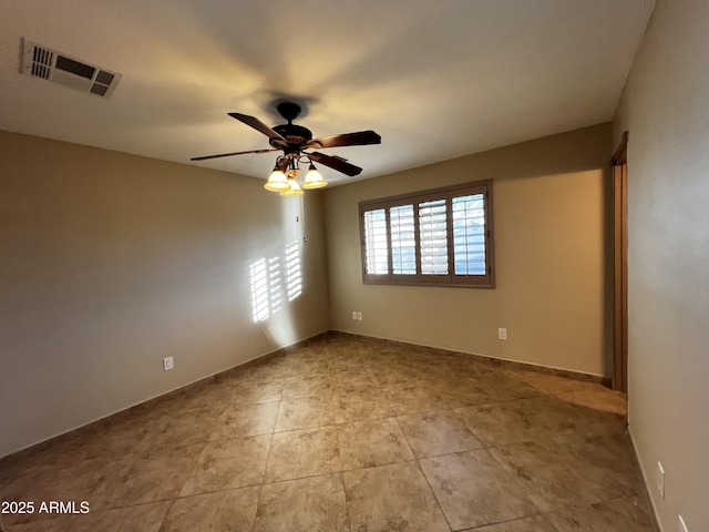 unfurnished room with light tile patterned floors and ceiling fan