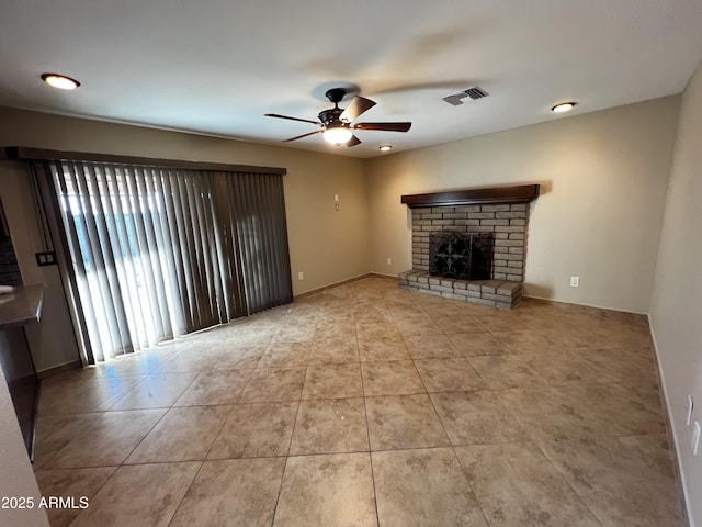 unfurnished living room with light tile patterned floors, a fireplace, and ceiling fan